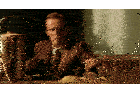 a man in a suit and tie sitting at a table