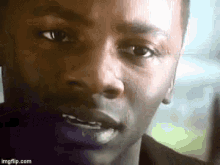 a close up of a person 's face with a blurred background