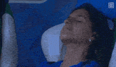 a woman is laying in a chair with a da zn logo on the bottom right