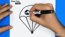 a person is drawing a parachute with a marker on a piece of paper that says draw cute things