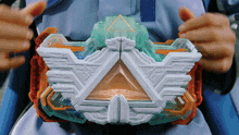 a person is holding a toy with a triangle in the middle