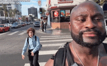 a man with a beard is standing in front of a burger king