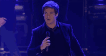 a man in a suit is standing with his arms outstretched