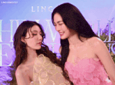two women standing next to each other in front of a lingormgifs poster