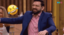 a man in a blue suit is laughing with a woman in an apron that says epi on it