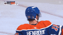 a hockey player wearing a jersey with the name henrique on the back