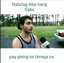a man in a tank top is talking into a microphone with the words natulong ako nang gabi