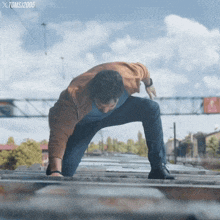 a man is crawling on a roof with the year 2005 on the bottom left