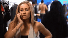 a woman talking on a cell phone with the hashtag #themv on the bottom left