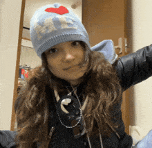a woman wearing a blue hat that says i love ny