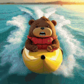 a teddy bear wearing a life jacket is riding a banana boat