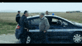 a gendarmerie car is parked on the side of a road