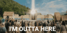 a crowd of people standing in front of a building with the words i 'm outta here written on the bottom