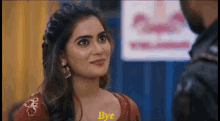 a woman in a red dress says bye in front of a man in a black jacket