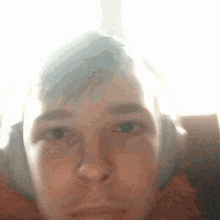 a close up of a person 's face with the sun shining through it