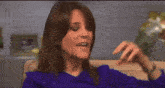 two women sitting on a couch talking to each other