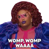 a drag queen says womp womp waaaa in a pink and blue dress