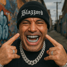 a man wearing a beanie and a necklace with the word blazzard on it