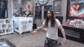 a man with long hair and a beard stands in front of a machine that says lucky draw