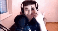 a young man wearing headphones is giving the middle finger .
