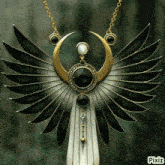a pixiz photo of a necklace with wings and a crescent moon on a chain