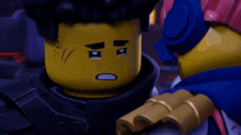 a close up of a lego character 's face with a sad look on his face