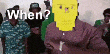 a group of men are standing in a room and one of them is wearing a yellow spongebob mask on his face .