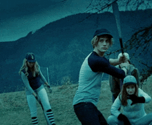 a man wearing a baseball cap with the letter g on it swings a bat