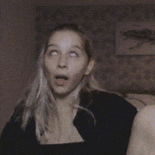 a woman is making a surprised face while another woman looks on