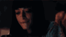 a close up of a woman 's face with a dark background