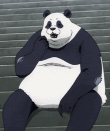 a panda bear is sitting in front of a wall and smiling