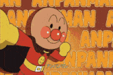 an anpanman cartoon character is standing in front of a wall of anpanman letters