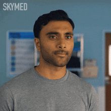 a close up of a man 's face with the words skymed behind him