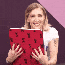 a woman with red nails is holding a red case that says pit on it