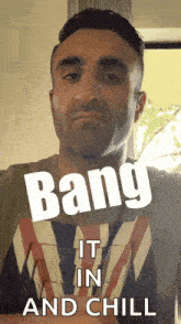a man with bang it in and chill on his shirt