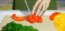 a person is cutting tomatoes on a cutting board .