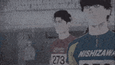 a group of athletes are walking on a track and one of them has the number 652 on his jersey