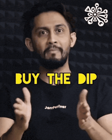 a man in a black shirt with the words buy the dip on it