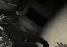a person is holding a steering wheel in their hand in a dark room