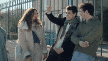 a group of people are standing next to each other and one of them is pointing