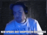 a man wearing headphones and a white shirt says new update just dropped on mobsteria