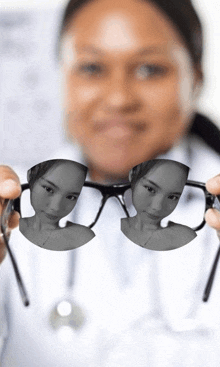 a woman is holding up a pair of glasses with a picture of a woman in them