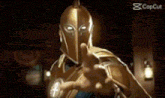 a man in a golden helmet is pointing his finger at the camera