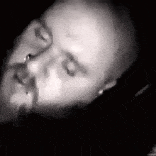a close up of a man 's face with his eyes closed and his mouth open .