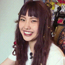a close up of a woman 's face with a microphone in her hair