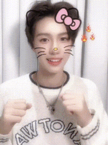 a young man wearing a hello kitty face mask is making a face .