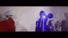 a group of people are standing in a room with a projector .