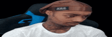 a man wearing a brown headband that says 3wp