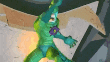 a green superhero with a purple star on his chest is standing in front of a wall .