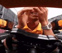 a man wearing a yellow shirt that says mclaren